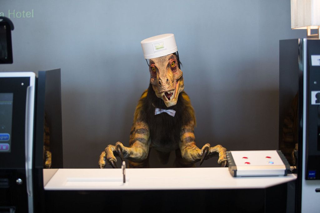 SASEBO, JAPAN - JULY 15: A robotic dinosaur replaces human staff at the check in counter at the Henna Hotel (Weird Hotel) in Huis Ten Bosch, Netherlands themed amusement park on July 15, 2015 in Sasebo, Japan. The Henna Hotel, scheduled to open on July 17, features multi-lingual humanoid robots that greet visitors while other robots serve coffee and do the cleaning, as well as room doors that are opened by face-recognition technology.  (Photo by Trevor Williams/WireImage)