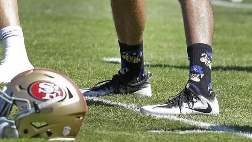 Colin Kaepernick usa calcetines de cerdos con gorra de policía - 1472757571075